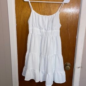 A white dress adorned with a delightful and intricate design